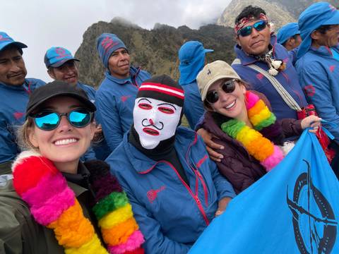       Group of people posing with colorful scarves.
  