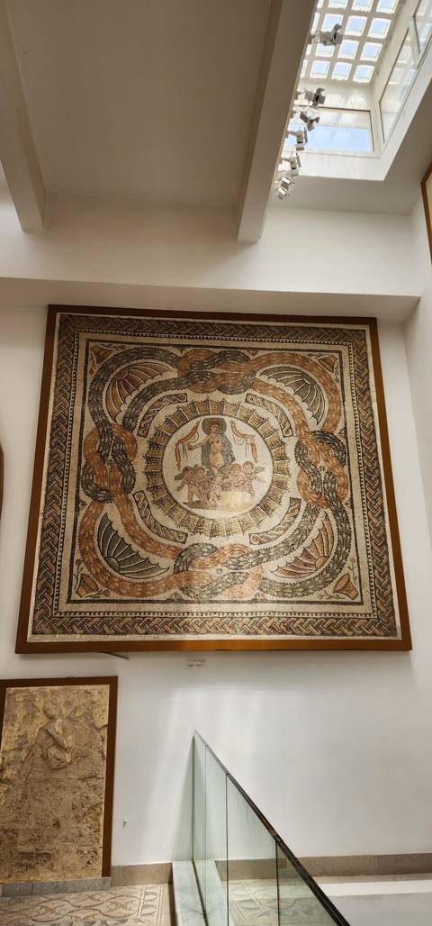 Mosaic artwork on display in an interior.