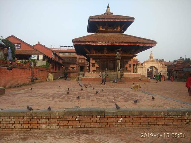       Traditional architecture with a square and pedestrians.
  