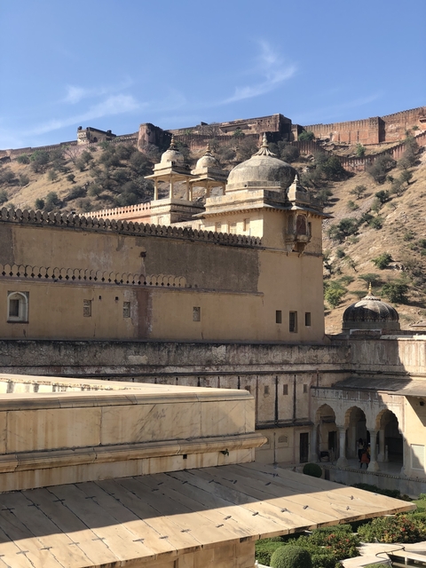       Amber Fort with detailed architecture and surrounding hills.
  