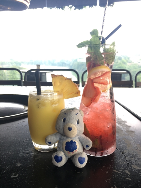 Beverages on a table with a scenic view in the background.