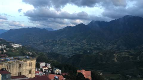 A panoramic view of mountainous terrain from a hilltop.