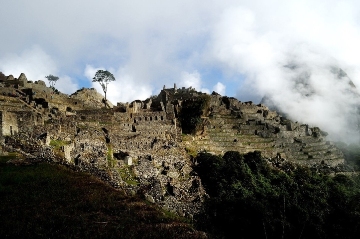Ruins of Machu Picchu against a cloudy backdrop.