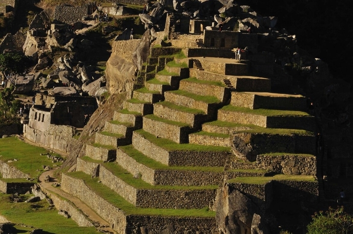Stepped agricultural terraces with stone structures.