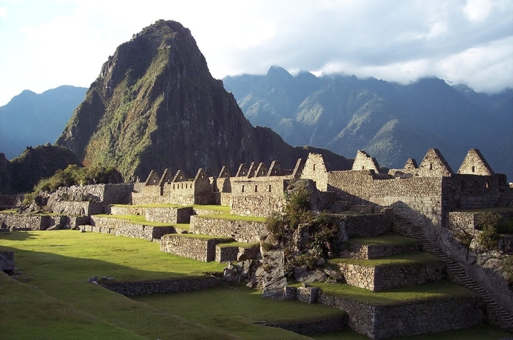 Sprawling Incan structures with mountain backdrop.