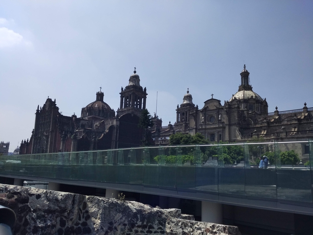 A grand cathedral with domed roofs against a blue sky.