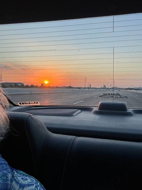       View through car window at sunset.
  