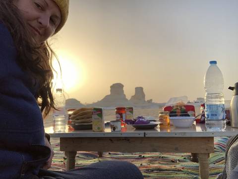 Upside down view of a table with various items and a person in the background.