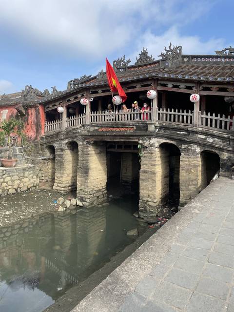       Bridge over water with traditional architectural elements.
  