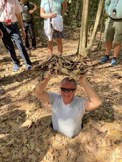       Person emerging from the ground surrounded by leaves.
  