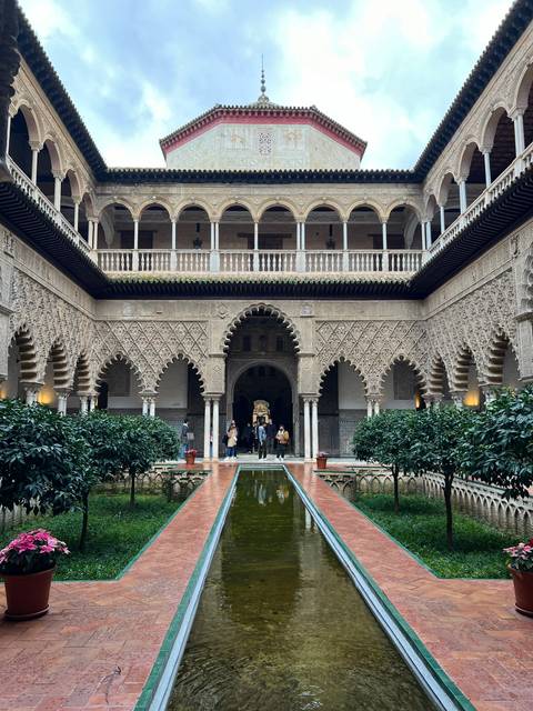 Decorative palace courtyard with a water feature and arches.
