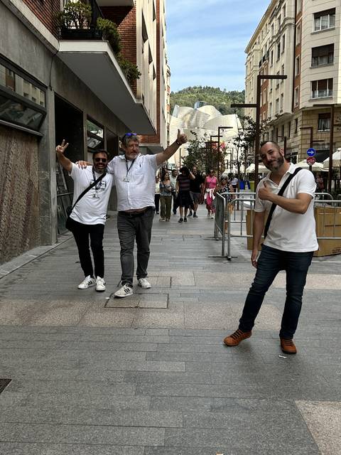       A group of people posing on a city street.
  