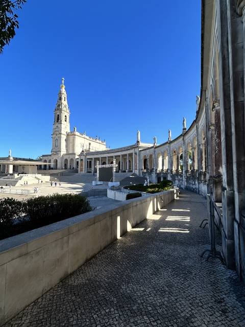 A monumental white basilica with a large open plaza.