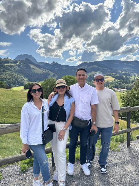 Group of people posing with a mountainous backdrop.