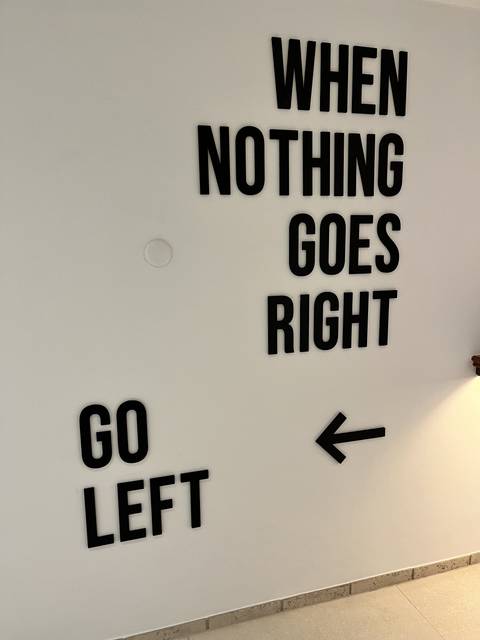       Motivational text on a white wall.
  