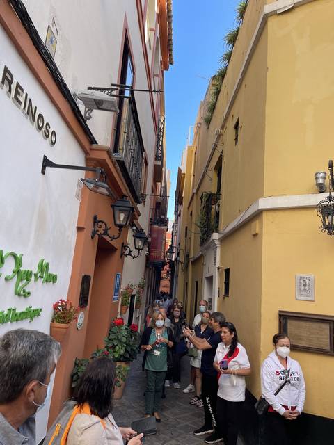 Group of people gathered in a narrow street
