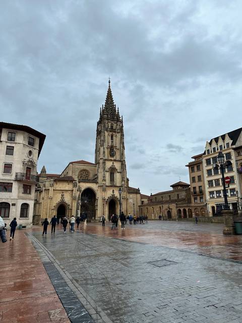 A cathedral with people walking around nearby.