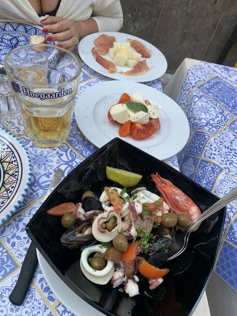       Various Mediterranean dishes at a dining table.
  