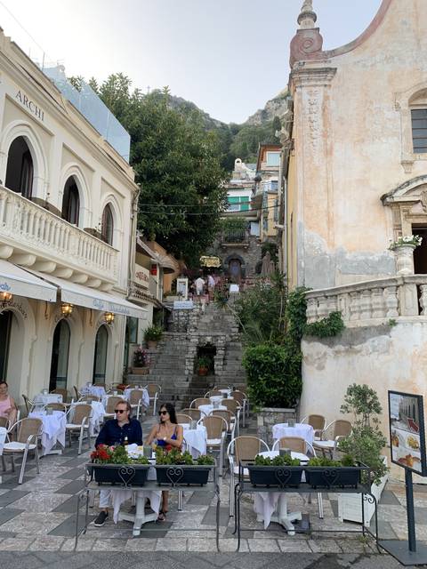       Outdoor cafe setting on a picturesque street.
  