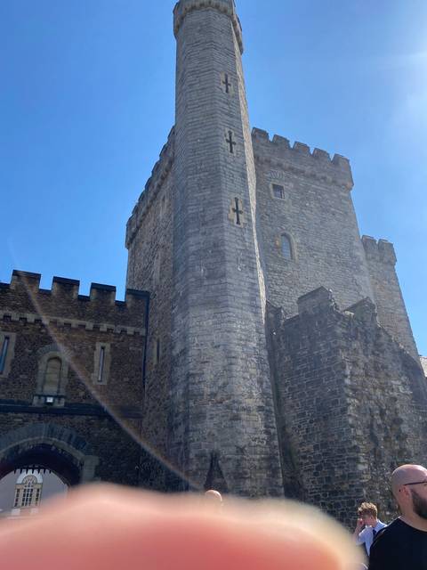 Stone tower with finger partially visible on the lens