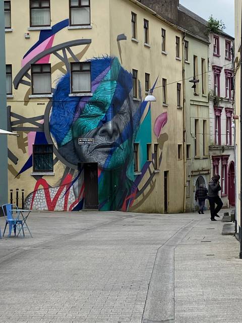 Large mural on a building with colorful designs