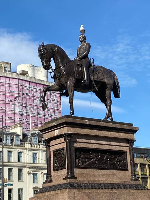 Statue of a man on a horse in a public square