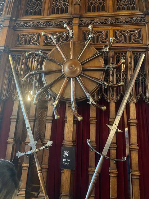 Display of swords on a wooden panel