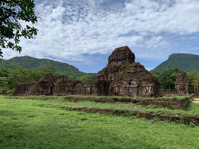 Ancient ruins with mountains in the background.