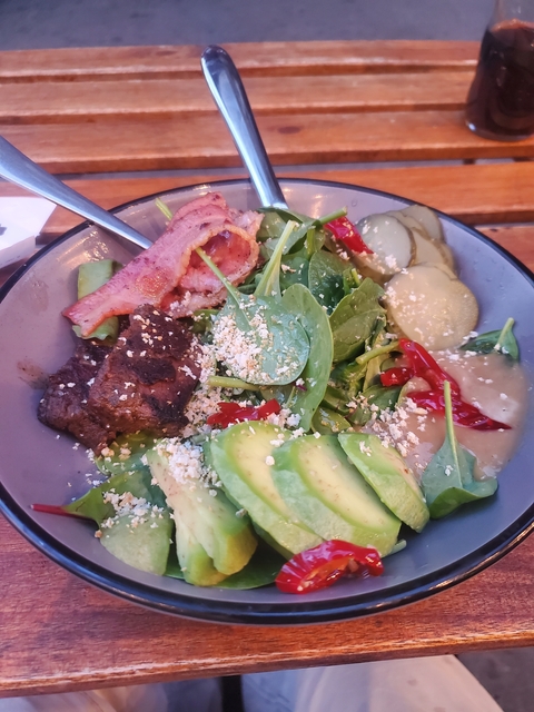      Salad with bacon, avocado, pickles, and dressing.
  