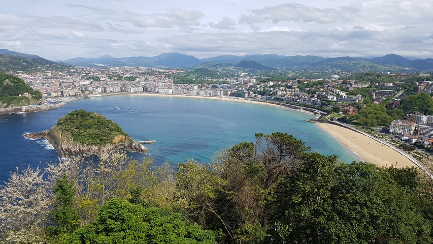       Stunning ocean bay surrounded by a coastal city and mountains.
  