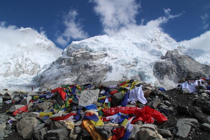Prayer flags in front of snowy mountains.