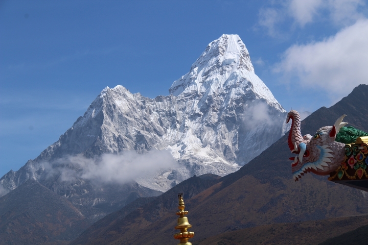Mountain range with decorative roof in the foreground.