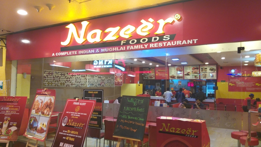       Colorful restaurant storefront with signage
  