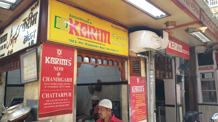 Street food vendor with signage and customers