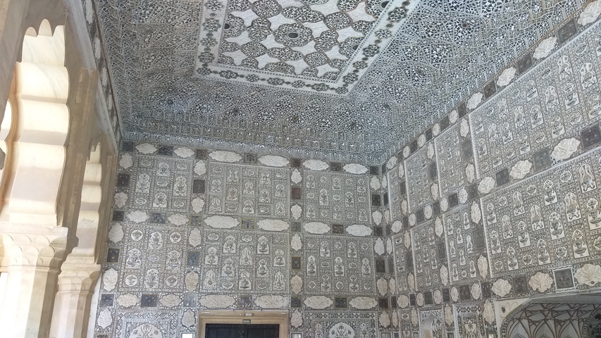       Decorated interior walls with detailed patterns and arches.
  