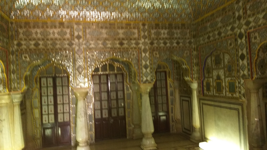       Ornate room with reflective decorations and pillars
  