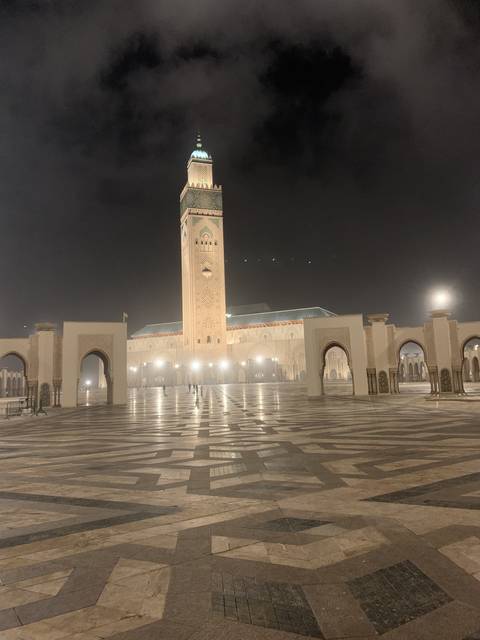       A large mosque lit up at night.
  