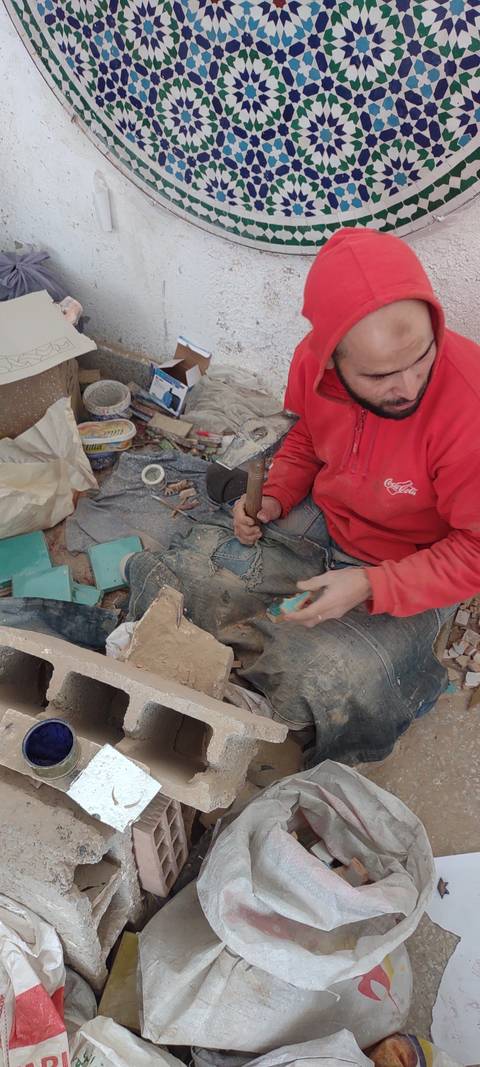       Man working with ceramics in a workshop.
  