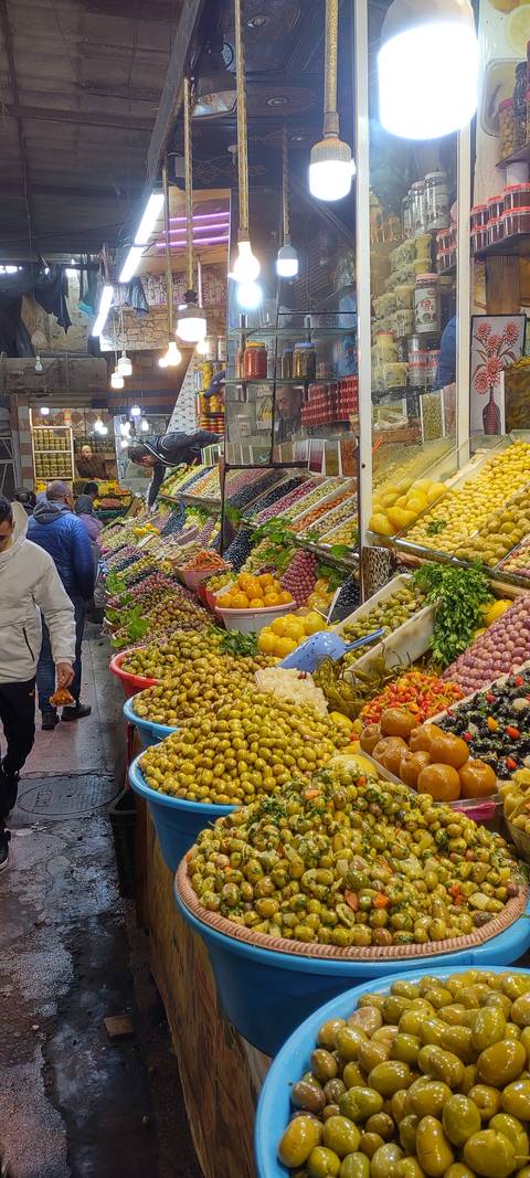 Bustling market with colorful produce and goods.