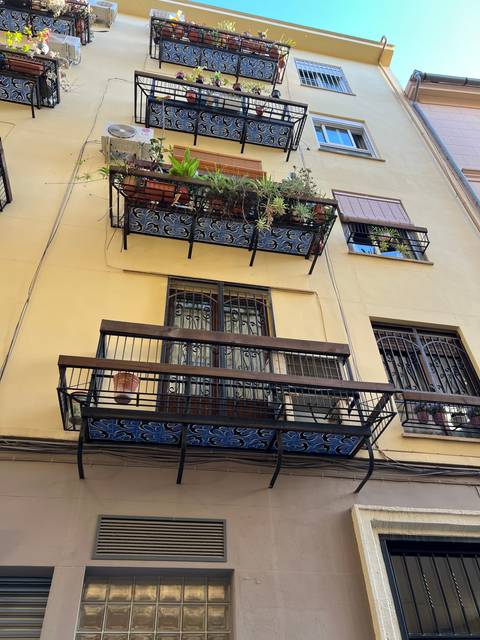 Building facade with decorative window grills.