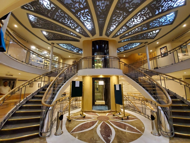Interior view of a ship with a grand staircase.