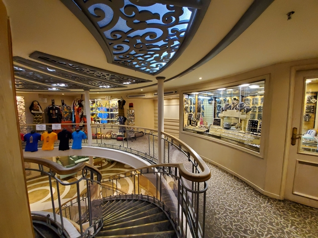 Interior shop area with souvenirs and clothing on display.