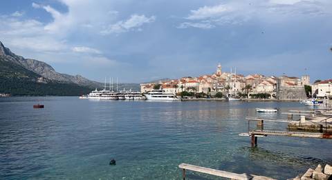 Docked yachts and coastal town buildings.