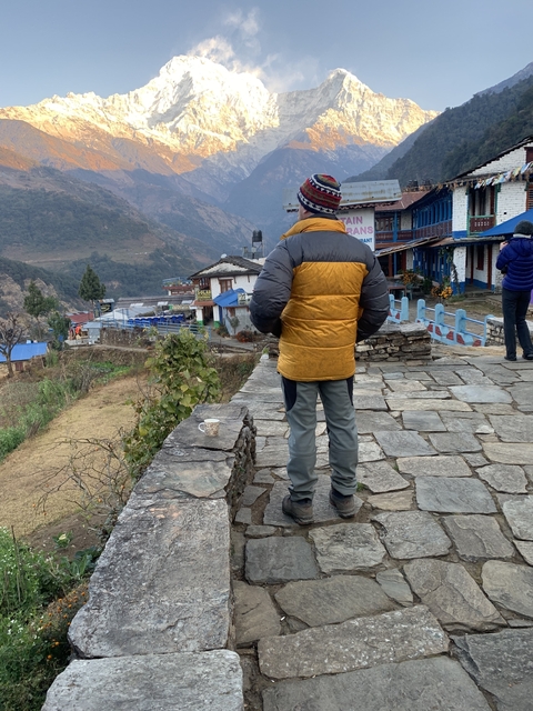       Person standing on stone path in a village
  