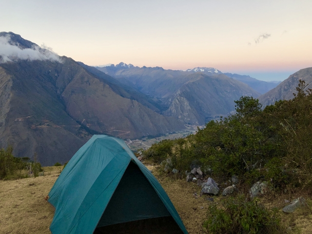 Tent set up in the mountains at sunset