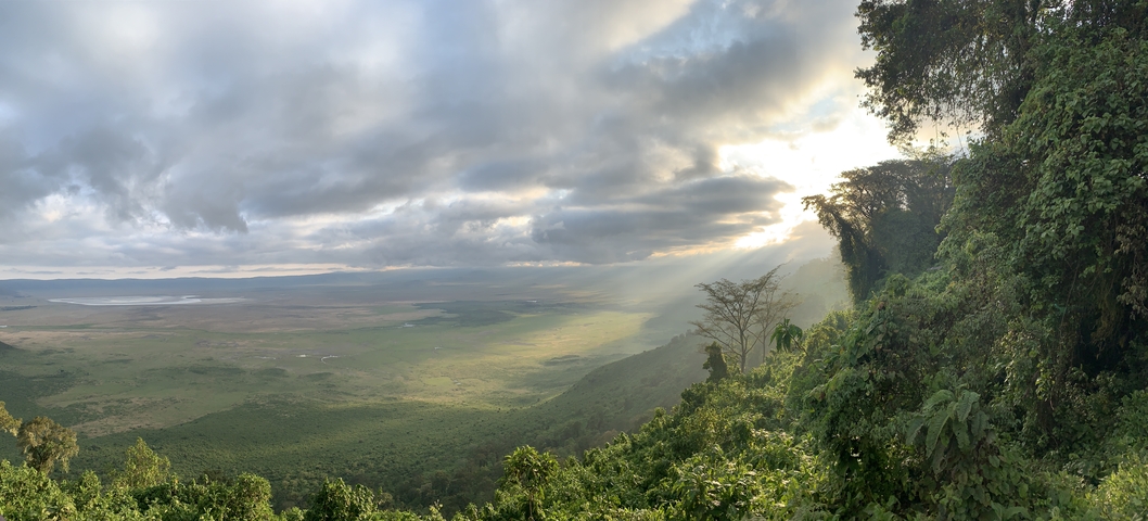 Dramatic landscape of clouds and sunlight over a vast expanse.