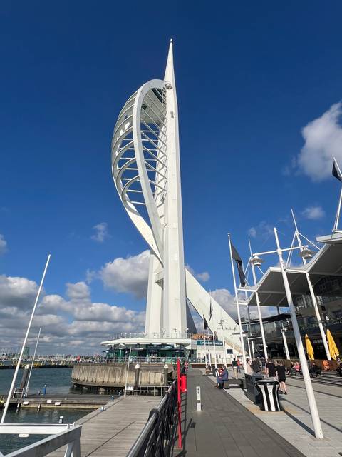       The Spinnaker Tower against a blue sky.
  