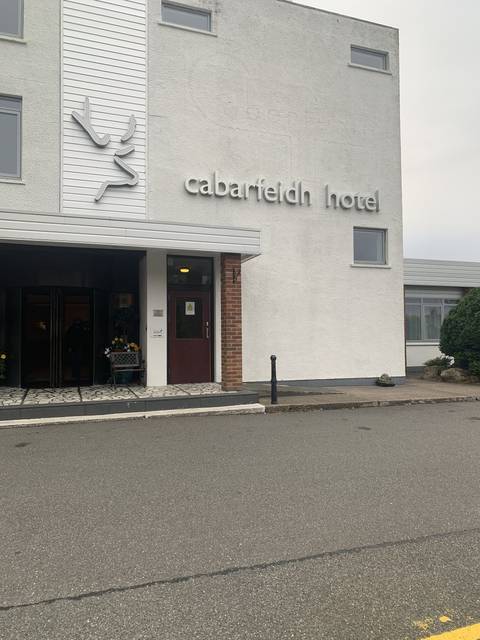 White modern hotel building with visible signage.