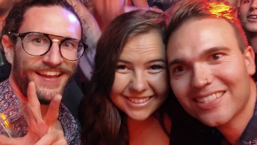 A group of smiling people at a social gathering.