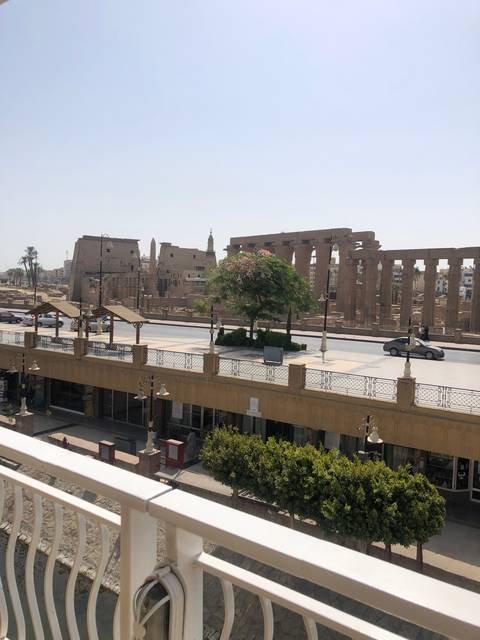 Cityscape view from a balcony with a railing.